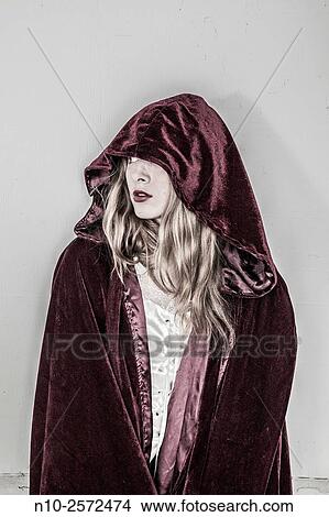 Blonde teenage girl wearing a robe with a hood. View Large Photo Image Picture - Blonde teenage girl wearing a robe with a hood.. Fotosearch