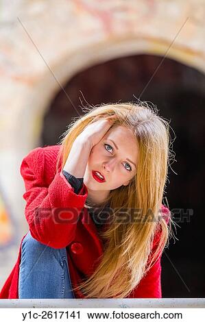 Stock Image - Blonde teenager girl looking at camera. Fotosearch