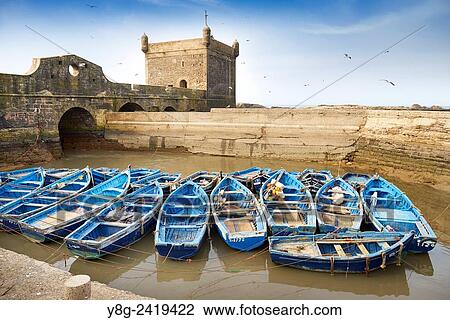 Blue fishing boats in the harbour of Essaouira, Morocco Morocco, Africa. View Large Photo Image Stock Image - Blue fishing boats in the harbour of Essaouira, Morocco Morocco, Africa.. Fotosearch