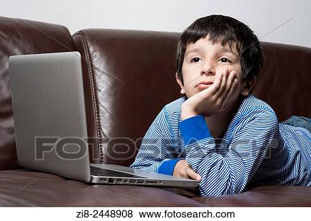 Boy, 6-7, on laptop computer. View Large Photo Image Stock Photo - Boy, 6-7, on laptop computer.. Fotosearch