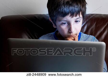 Boy, 6-7, on laptop computer. View Large Photo Image Stock Photo - Boy, 6-7, on laptop computer.. Fotosearch