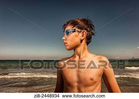 Picture - Boy wearing swimming googles at seaside.. Fotosearch