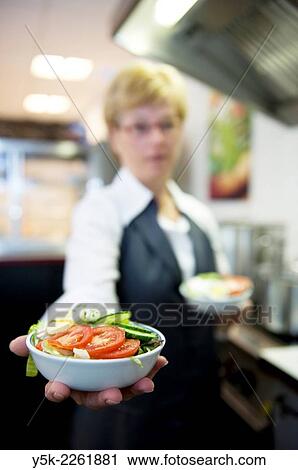 Breda, Netherlands. Female employee working an office canteen or lunchroom, making salads and other food. View Large Photo Image Stock Image - Breda, Netherlands. Female employee working an office canteen or lunchroom, making salads and other food.. Fotosearch