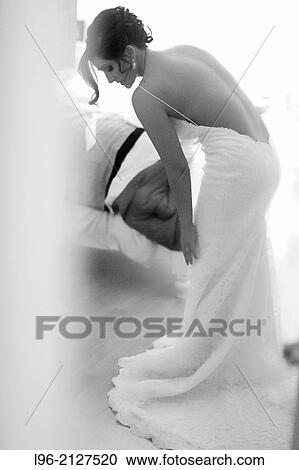 Bride getting ready for her wedding, in her gorgeous wedding dress View Large Photo Image Stock Image - Bride getting ready for her wedding, in her gorgeous wedding dress. Fotosearch