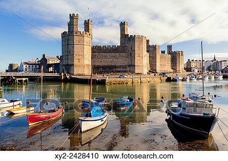 Caernarfon or Carnarvon or Caernarvon, Gwynedd, Wales, United Kingdom. Caernarfon Castle seen across the River Seiont. View Large Photo Image Stock Image - Caernarfon or Carnarvon or Caernarvon, Gwynedd, Wales, United Kingdom. Caernarfon Castle seen across the River Seiont.. Fotosearch