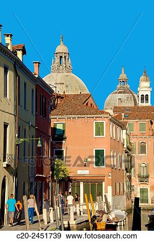 Canal and tourists, La Salute Church, domes, in the background, Dorsoduro, Venice, Venetia, Italy. View Large Photo Image Stock Photo - Canal and tourists, La Salute Church, domes, in the background, Dorsoduro, Venice, Venetia, Italy.. Fotosearch