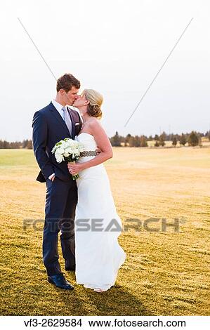 Central Oregon wedding day portrait of the bride and groom outdoors in the Winter. View Large Photo Image Picture - Central Oregon wedding day portrait of the bride and groom outdoors in the Winter.. Fotosearch