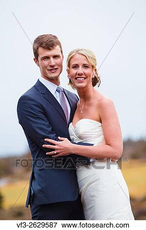 Stock Photo - Central Oregon wedding day portrait of the bride and groom outdoors in the Winter.. Fotosearch