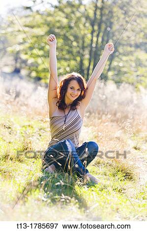 Cheerful girl on a grass-field View Large Photo Image Stock Photo - Cheerful girl on a grass-field. Fotosearch