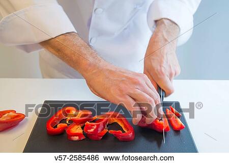 Chef´s hands cutting red pepper on the chopping board. Close view. View Large Photo Image Stock Photograph - Chef´s hands cutting red pepper on the chopping board. Close view.. Fotosearch