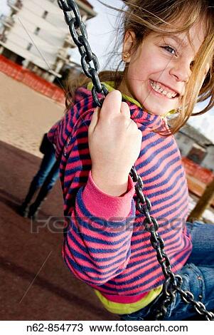 Child on the playground swing View Large Photo Image Stock Image - Child on the playground swing. Fotosearch