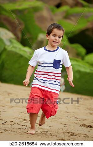 Child playing on the beach. Getaria. Gipuzkoa. Basque Country. Spain View Large Photo Image Picture - Child playing on the beach. Getaria. Gipuzkoa. Basque Country. Spain. Fotosearch