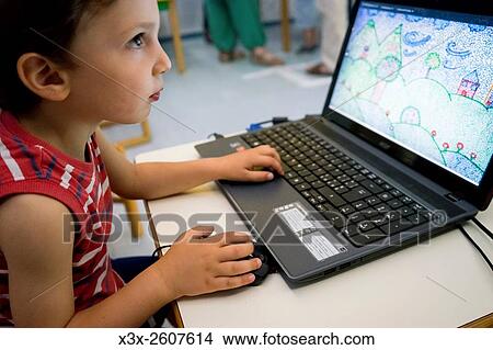 Child playing with a laptop computer. View Large Photo Image Picture - Child playing with a laptop computer.. Fotosearch