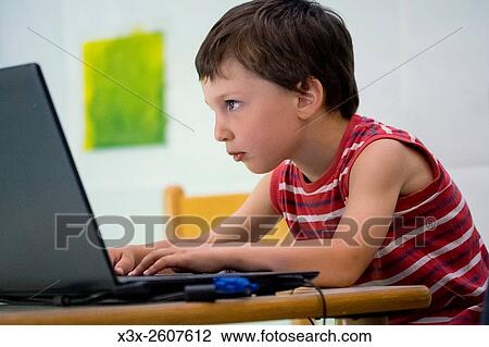 Child playing with a portable pc View Large Photo Image Stock Image - Child playing with a portable pc. Fotosearch