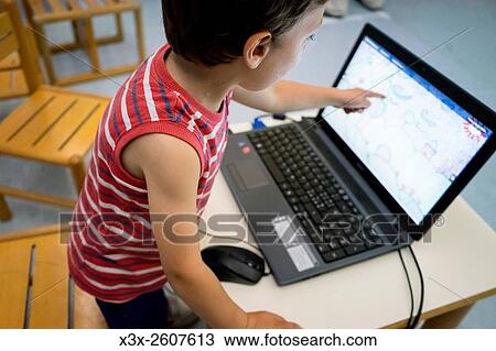 Child pointing at a computer screen View Large Photo Image Stock Image - Child pointing at a computer screen. Fotosearch