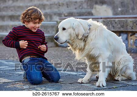 Child with dog playing in the park. Zumaia. Gipuzkoa. Basque Country. Spain View Large Photo Image Stock Photo - Child with dog playing in the park. Zumaia. Gipuzkoa. Basque Country. Spain. Fotosearch