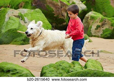 Child with dog playing on the beach. Getaria. Gipuzkoa. Basque Country. Spain View Large Photo Image Stock Image - Child with dog playing on the beach. Getaria. Gipuzkoa. Basque Country. Spain. Fotosearch