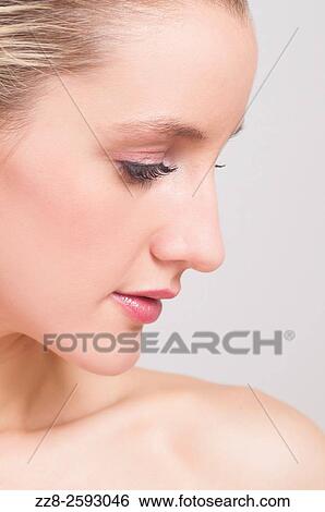 Stock Photograph - Close up of a beautiful young woman looking away.. Fotosearch