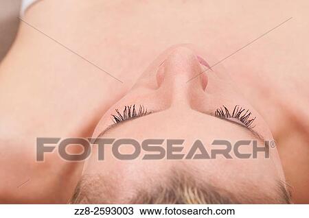 Close up of a woman lying down eyes closed. View Large Photo Image Stock Image - Close up of a woman lying down eyes closed.. Fotosearch