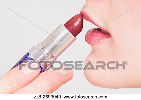 Close up of a young woman applying make up lipstick. View Large Photo Image Stock Image - Close up of a young woman applying make up lipstick.. Fotosearch