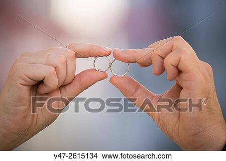 Close-up of wedding rings and hands of the bride and groom View Large Photo Image Picture - Close-up of wedding rings and hands of the bride and groom. Fotosearch