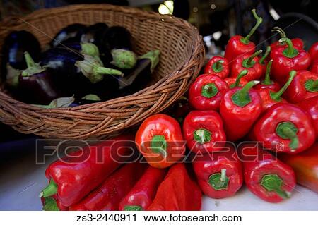 Stock Image - Close-Up shot of aubergines and red peppers in a basket at the shop, Rethymno, Crete, Greek Islands, Greece, Europe.. Fotosearch