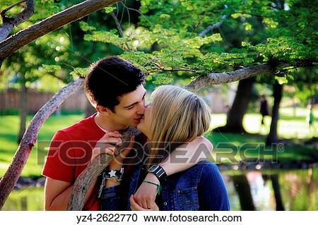 Closeup of a young couple outdoors kissing. View Large Photo Image Stock Image - Closeup of a young couple outdoors kissing.. Fotosearch