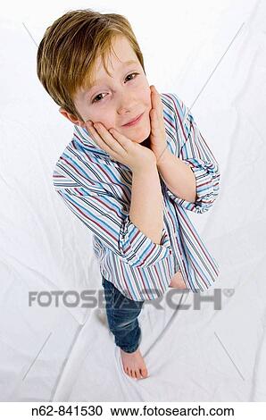 Concerned that the child puts his hands on her face View Large Photo Image Stock Image - Concerned that the child puts his hands on her face. Fotosearch