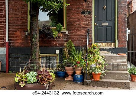 Stock Image - Container plants in front of a row house in Pittssburgh.. Fotosearch