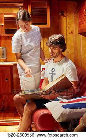 Stock Photograph - Couple inside a sailboat, galleon. Basque Country. Spain. Fotosearch