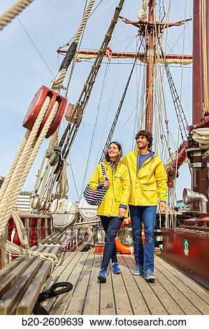 Stock Photo - Couple outside a sailboat, galleon. Masts. Basque Country. Spain. Fotosearch
