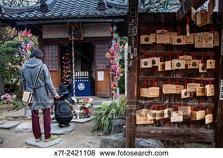 Couple praying. Temple area dedicated to dead unborn children, in Zojoji temple, Tokyo, Japan. View Large Photo Image Stock Photo - Couple praying. Temple area dedicated to dead unborn children, in Zojoji temple, Tokyo, Japan.. Fotosearch