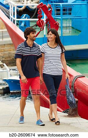 Couple walking in the fishing port. Getaria. Gipuzkoa. Basque Country. Spain View Large Photo Image Picture - Couple walking in the fishing port. Getaria. Gipuzkoa. Basque Country. Spain. Fotosearch