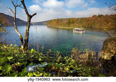 Croatia - autumn landscape of Plitvice Lakes National Park, electric power ferry boat on the lake, Plitvice, central Croatia. View Large Photo Image Stock Image - Croatia - autumn landscape of Plitvice Lakes National Park, electric power ferry boat on the lake, Plitvice, central Croatia.. Fotosearch