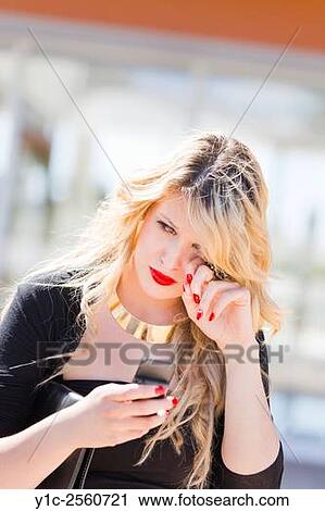 Crying lady with cellular phone in hand View Large Photo Image Stock Image - Crying lady with cellular phone in hand. Fotosearch