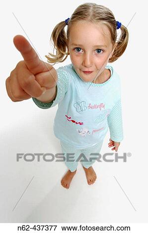 Curious little girl top view shows the index finger lifting the arm upwards View Large Photo Image Stock Photo - Curious little girl top view shows the index finger lifting the arm upwards. Fotosearch