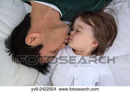 Picture - Dad kissing his toddler girl.. Fotosearch