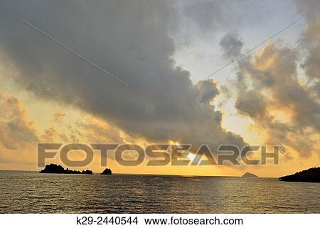 Dawn skies over the Devil's Crown, Galapagos Islands National Park, Floreana Island, Ecuador. View Large Photo Image Picture - Dawn skies over the Devil's Crown, Galapagos Islands National Park, Floreana Island, Ecuador.. Fotosearch