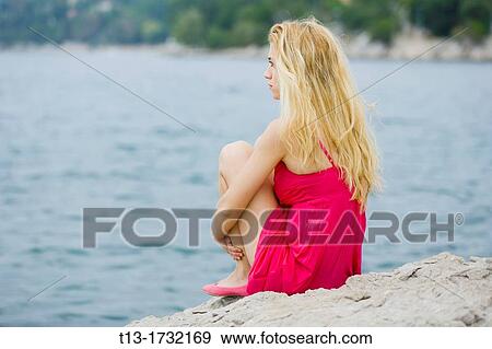 Day-dreaming on the shore pretty young woman View Large Photo Image Stock Photo - Day-dreaming on the shore pretty young woman. Fotosearch