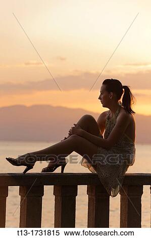 Daydreaming on a fence young woman View Large Photo Image Stock Photography - Daydreaming on a fence young woman. Fotosearch
