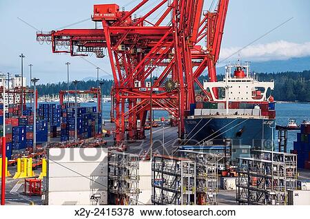 Docked cargo ship being loaded with containers for export, Vancouver, British Columbia, Canada. View Large Photo Image Stock Photo - Docked cargo ship being loaded with containers for export, Vancouver, British Columbia, Canada.. Fotosearch