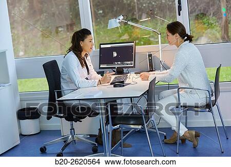 Doctor attending to patient medical consultation. Office. Plastic surgery. View Large Photo Image Picture - Doctor attending to patient medical consultation. Office. Plastic surgery.. Fotosearch