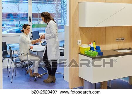 Doctor attending to patient medical consultation. Office. Plastic surgery. View Large Photo Image Stock Photo - Doctor attending to patient medical consultation. Office. Plastic surgery.. Fotosearch