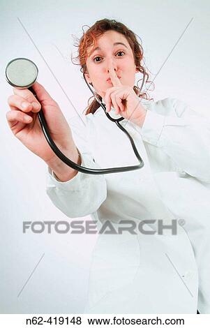 Doctor bottom view puts her index finger in front of the nose as if to say be quiet while a stethoscope is holding View Large Photo Image Stock Photo - Doctor bottom view puts her index finger in front of the nose as if to say be quiet while a stethoscope is holding. Fotosearch