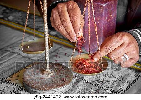 Stock Image - Dried saffron in a herbalist shop when weighing. Atlas Mountains region. Morocco.. Fotosearch