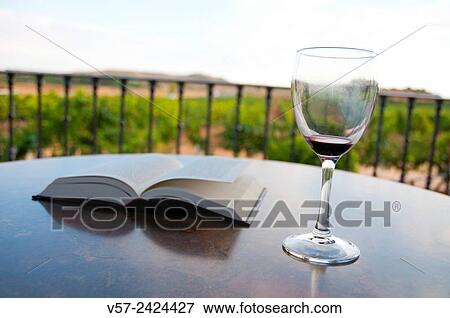 Empty glass of red wine and open book. View Large Photo Image Stock Photo - Empty glass of red wine and open book.. Fotosearch