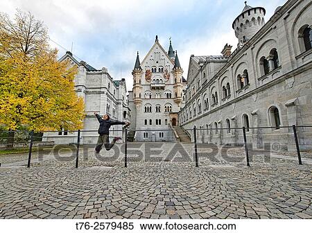Enjoying Schloss Neuschwanstein castle near Fussen in Bavaria, Germany. View Large Photo Image Stock Photography - Enjoying Schloss Neuschwanstein castle near Fussen in Bavaria, Germany.. Fotosearch