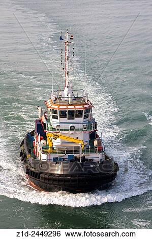 Stock Photograph - Escort tugs for very large passenger ship transiting the Suez Canal. Egypt.. Fotosearch