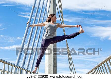 Extended hand to big toe yoga pose performed on a bridge, San Diego, California. View Large Photo Image Stock Image - Extended hand to big toe yoga pose performed on a bridge, San Diego, California.. Fotosearch