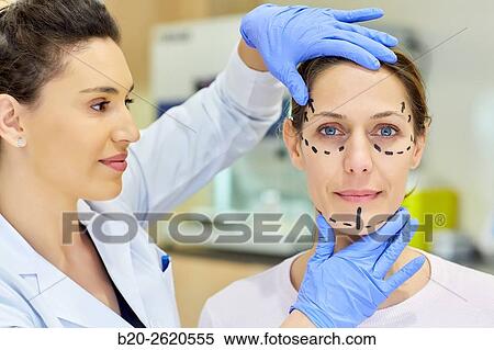 Stock Photography - Facelift. Blepharoplasty. Rhytidoplasty. It involves stretching the facial skin in order to remove wrinkles. Before surgery it is necessary to mark the facial aesthetic units and choose the voltage vectors that apply in the intervention. Plastic surgery. . Fotosearch